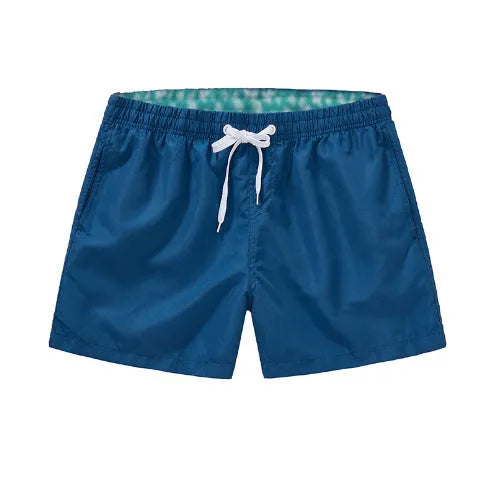 Men's polyester beach shorts with straight leg opening in multiple colours including black, white, and fluorescent yellow