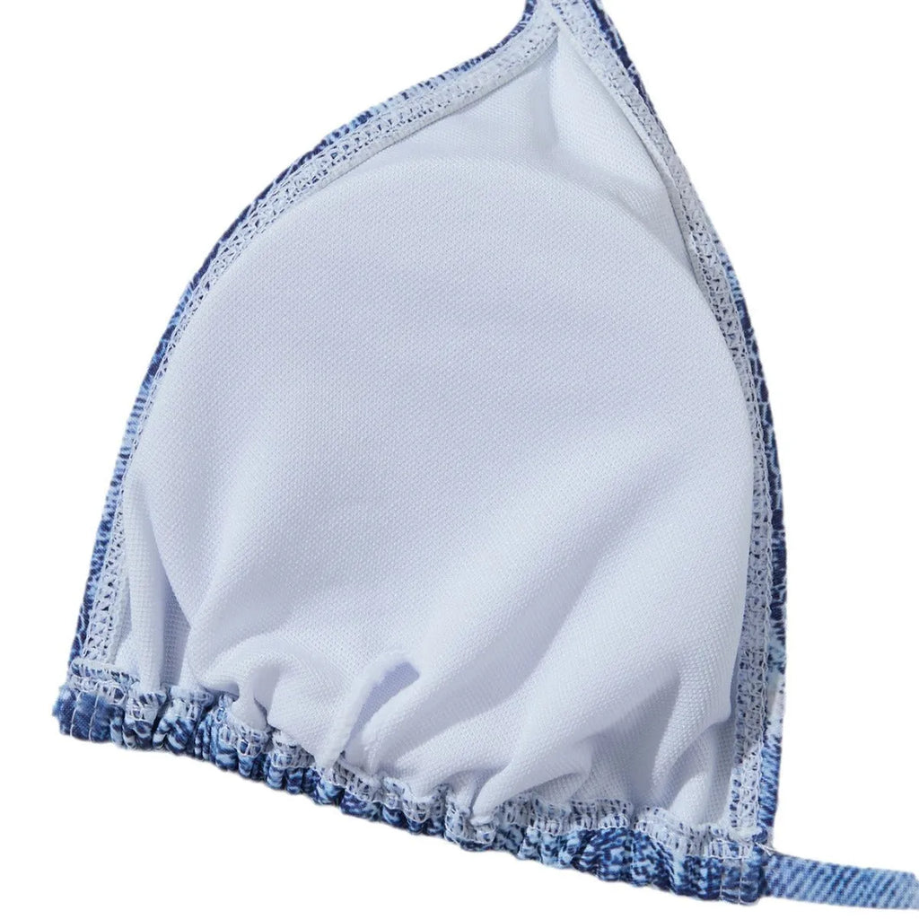 Women's denim blue printed bikini swimsuit with strap design on a hanger