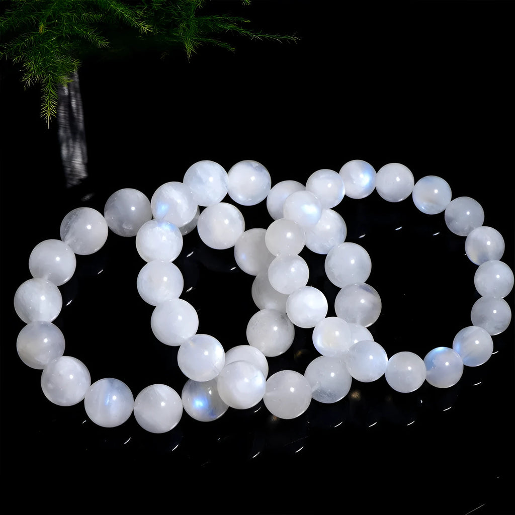 Natural blue moonlight round bead moonstone bracelet showing polished stone beads on wrist