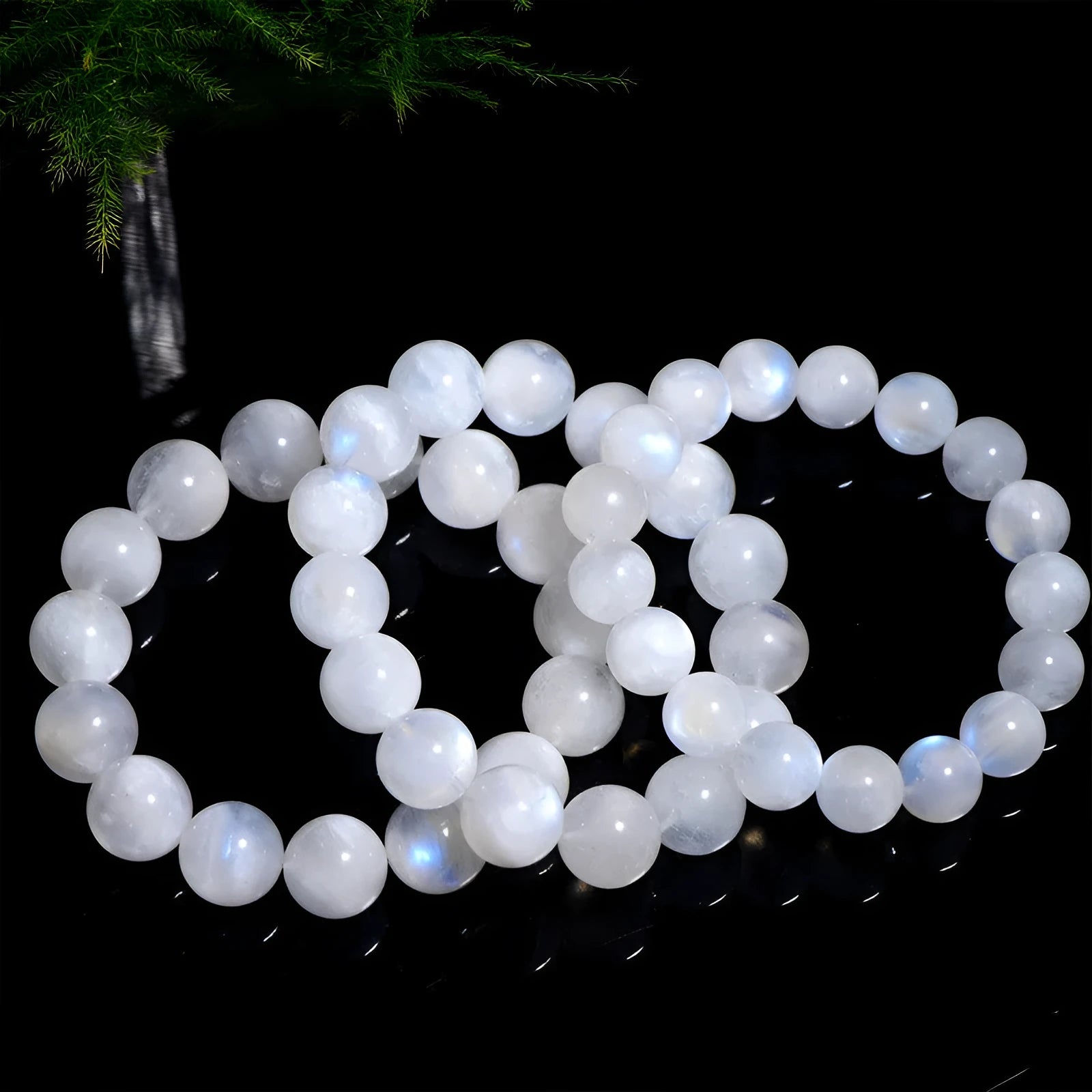 Natural blue moonlight round bead moonstone bracelet showing polished stone beads on wrist