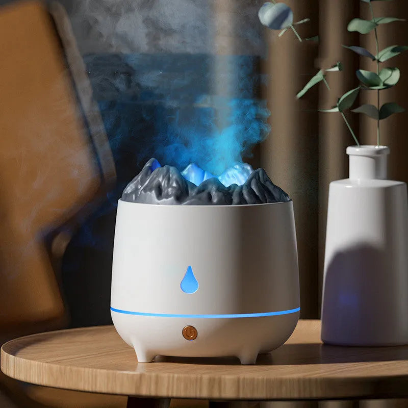 White volcano-shaped ultrasonic humidifier with USB cable on a wooden table.