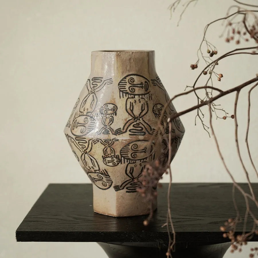 Hand-painted ceramic vase with vintage carved religious patterns in cylindrical shape