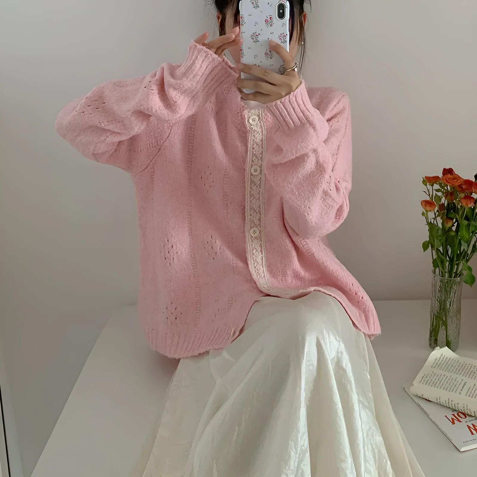 Loose apricot-coloured retro-style knit cardigan coat on a hanger