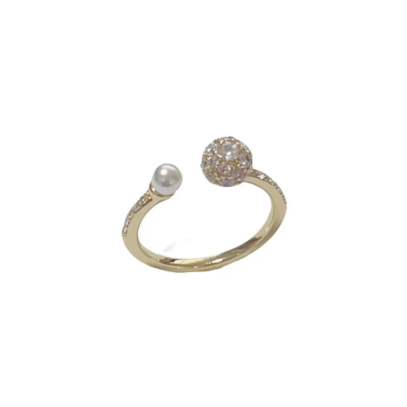 Open-end pearl ring with round zircon stone in gold or silver finish on geometric copper band