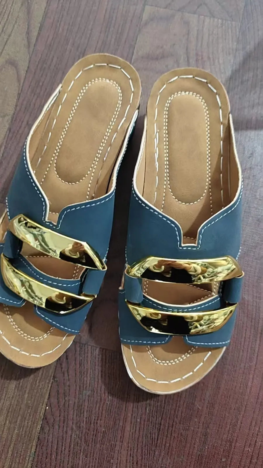 Roman-style platform flip-flops in a solid colour with a metal detail and rubber sole.