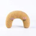 Blue question mark shaped cloth pillow for cat neck support on a pet sleeping mat