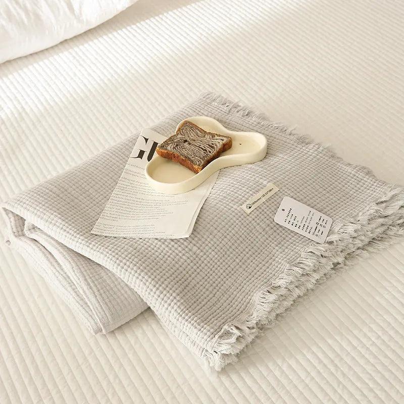 Four-layer gauze cotton blanket with tassel detailing in avocado green colour