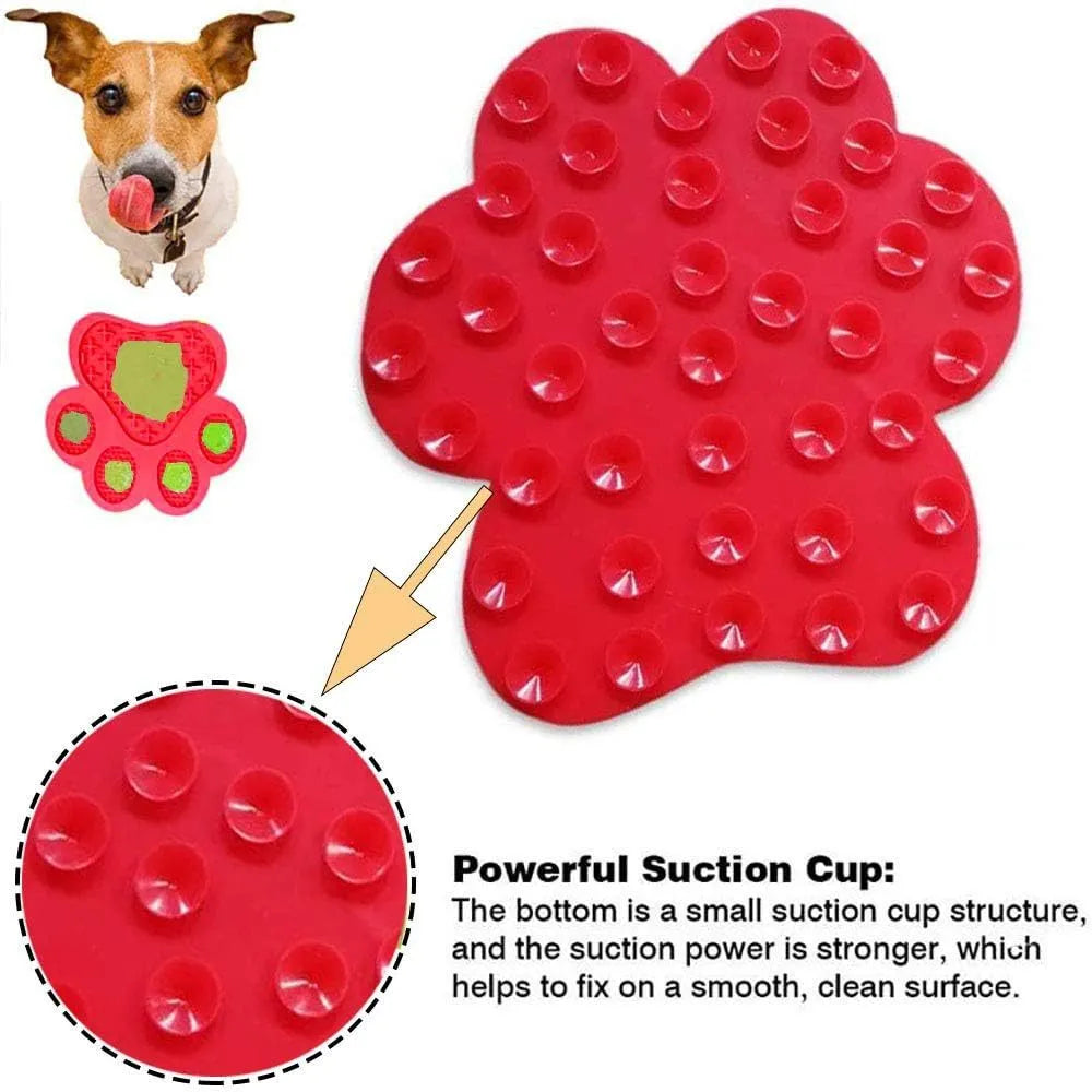 Blue silicone dog licking mat with bone texture and suction cups on a white bathroom tile.