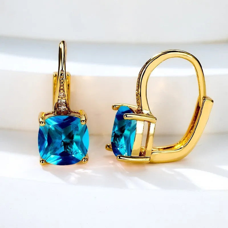 Square geometric ear hook earrings with zircon stones in an electroplated copper setting.
