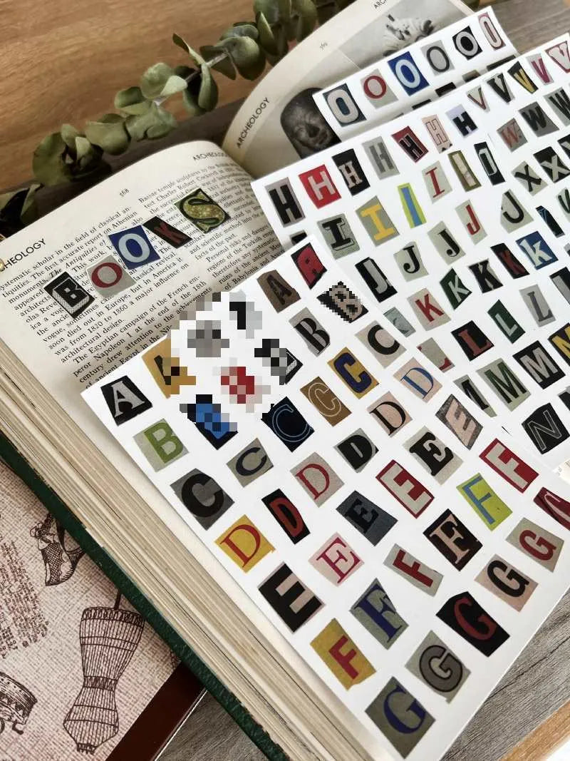 Decorative sticker sets showing English letters, numbers, and week words in colourful printed designs for crafting and labelling