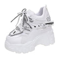White women's mesh platform tennis shoes with cross strap and a thick rubber sole.