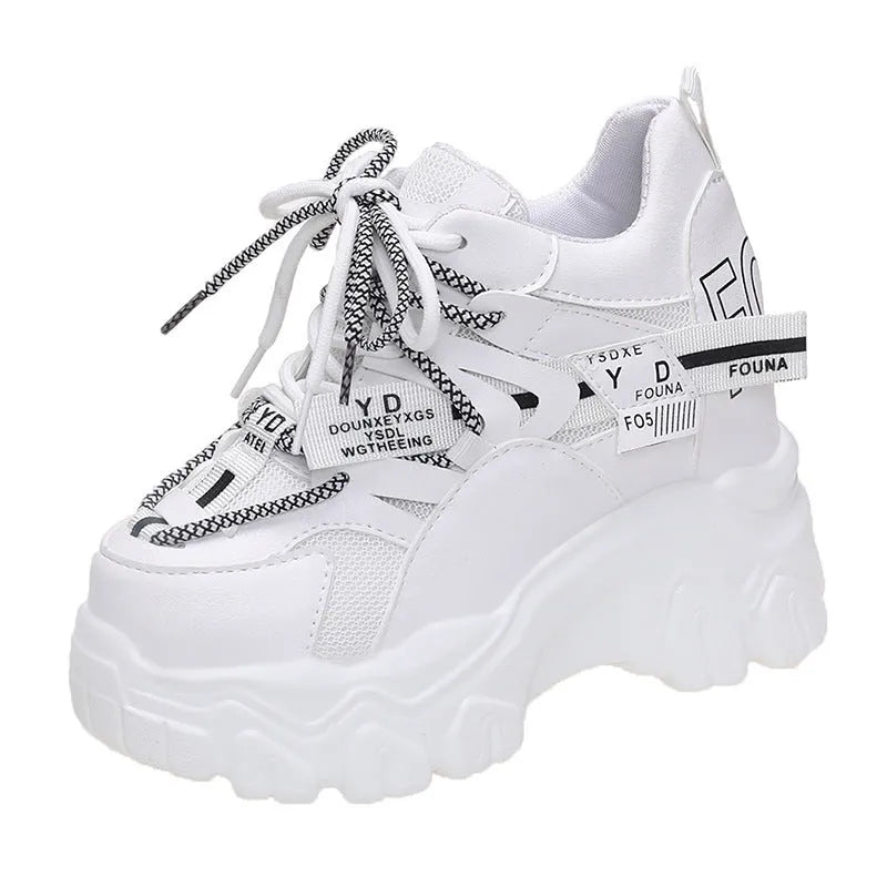 White women's mesh platform tennis shoes with cross strap and a thick rubber sole.