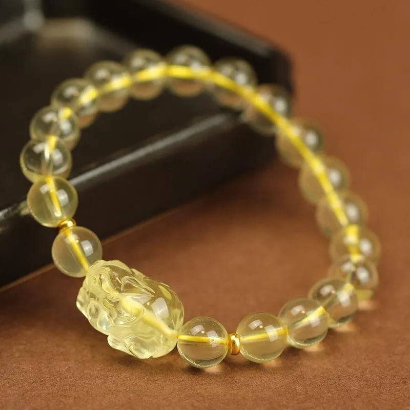Yellow Pi Xiu bracelet with artificial crystal bead on leather cord, Chinese zodiac design