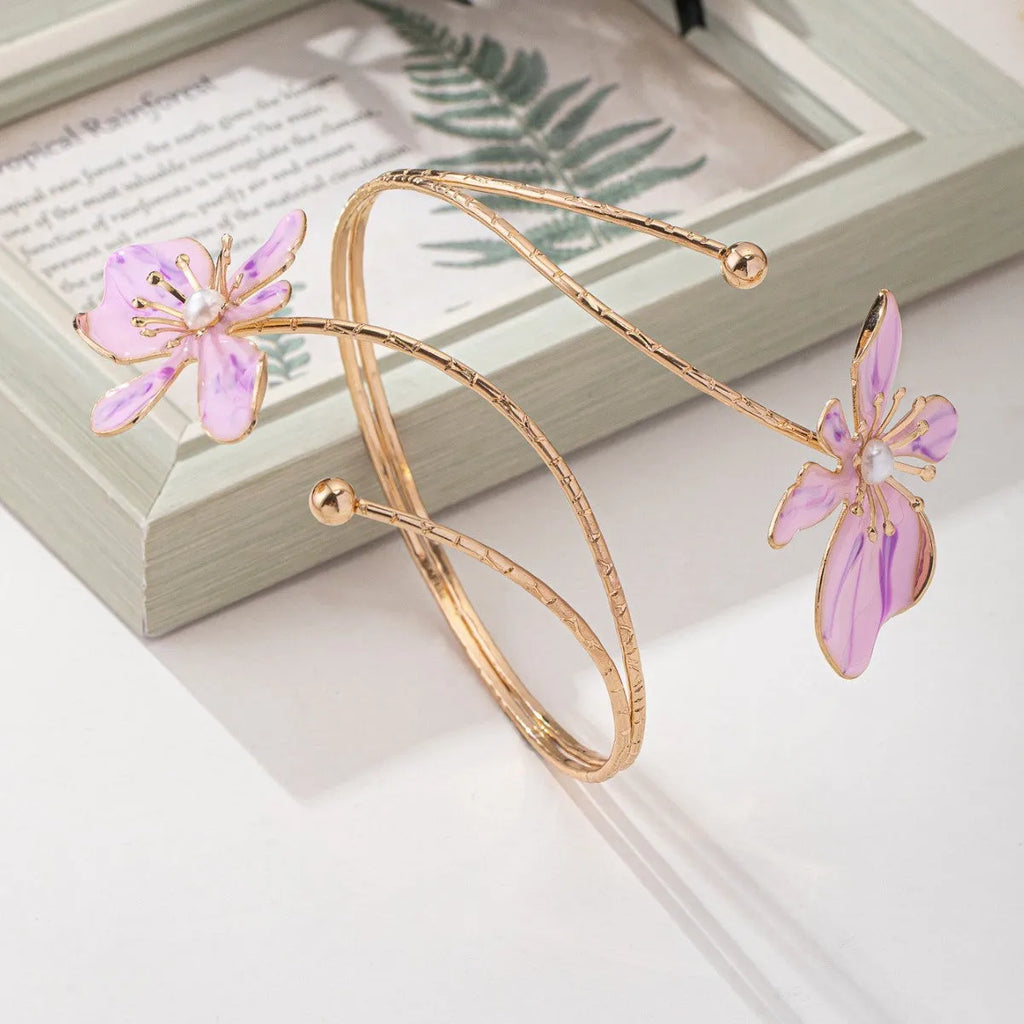 Pink alloy armband bracelet with hollow geometric linear pattern.