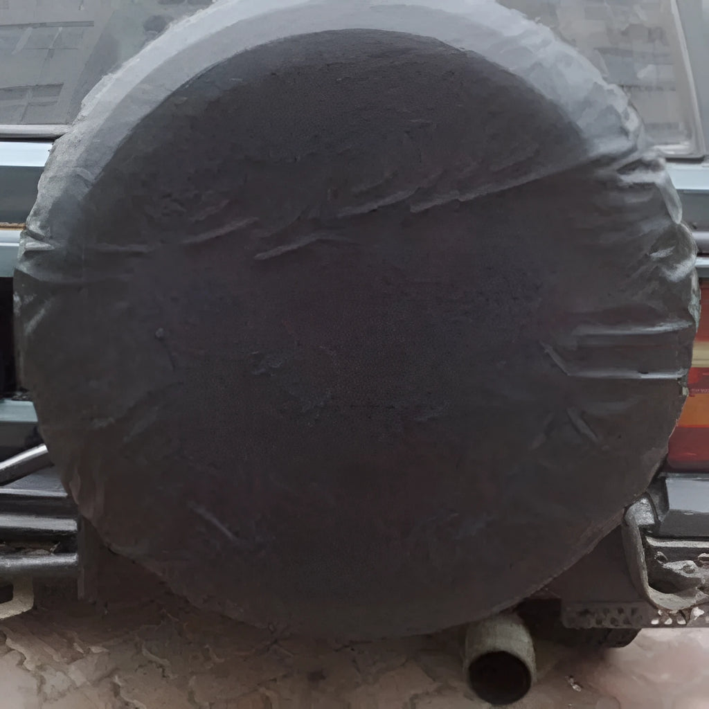 Pure black PVC faux leather spare tyre bag on a 16 inch car wheel