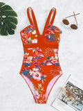 Women's floral patterned, backless one-piece swimsuit on a hanger