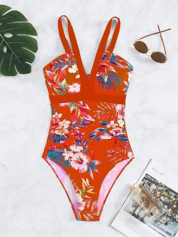 Women's floral patterned, backless one-piece swimsuit on a hanger