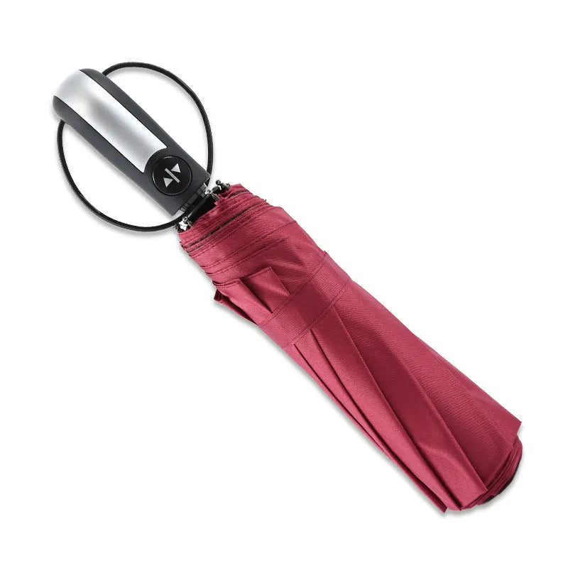 Triple-fold automatic open business umbrella in black, showing palace-style shape and rubber handle.