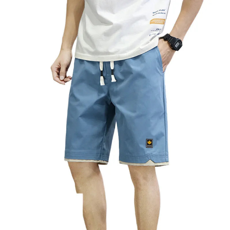 Man wearing loose-fit green casual beach shorts in a South Korea style, showing the straight cut and relaxed fit.