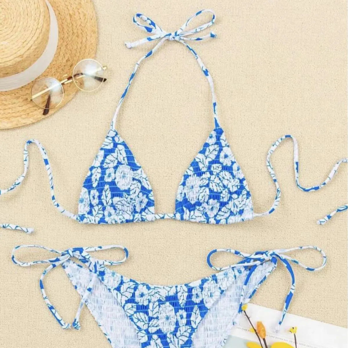 Women's pink floral halter neck swimsuit top and briefs set on a neutral background