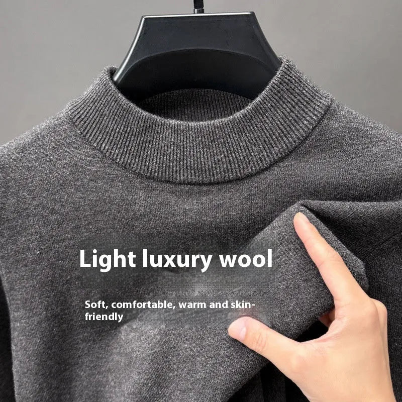 Men's solid colour fine yarn half-turtleneck long sleeve pullover on a hanger.