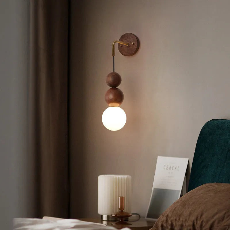 Walnut and copper suspension wall lamp with tri-colour light on a wall