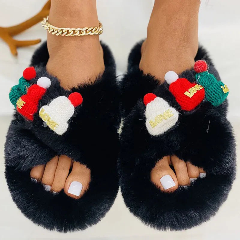 Women's black Christmas slippers with Santa hat decoration on plush faux fur upper.