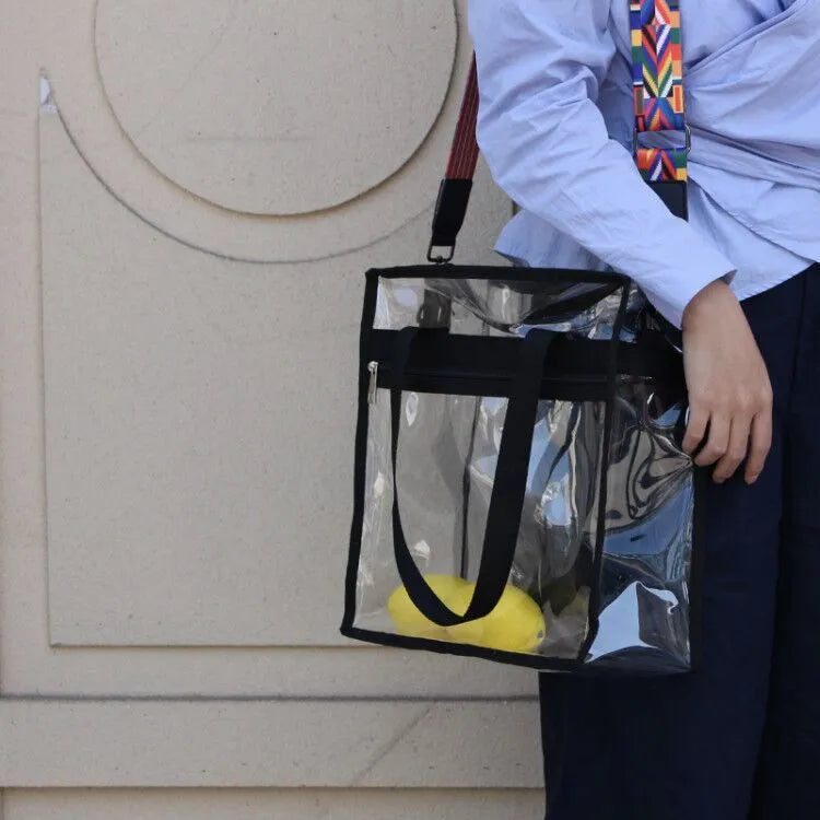 Women's transparent PVC crossbody messenger bag showing front 3D pocket and double shoulder straps.