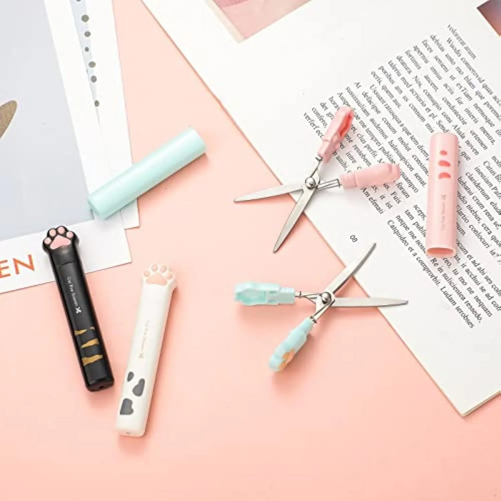Cat paw mini folding scissors showing stainless steel blades and four colour options: pink, white, black, and blue