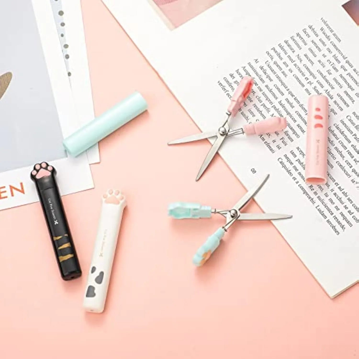 Cat paw mini folding scissors showing stainless steel blades and four colour options: pink, white, black, and blue