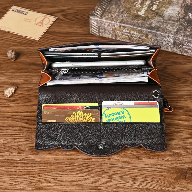 Women's brown genuine leather tri-fold wallet with embossed floral pattern showing open compartments