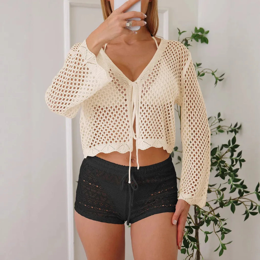 Short women's cardigan blouse with bell sleeves in a hollow woven cotton-like fabric.