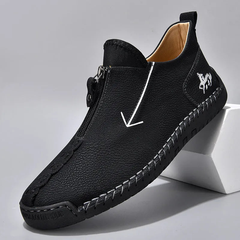 Men's black zip-up Martin boot with round toe and low heel on a white background.