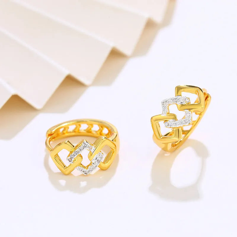 Geometric hollow-out gold-colour alloy earrings with an ear clip fastening.