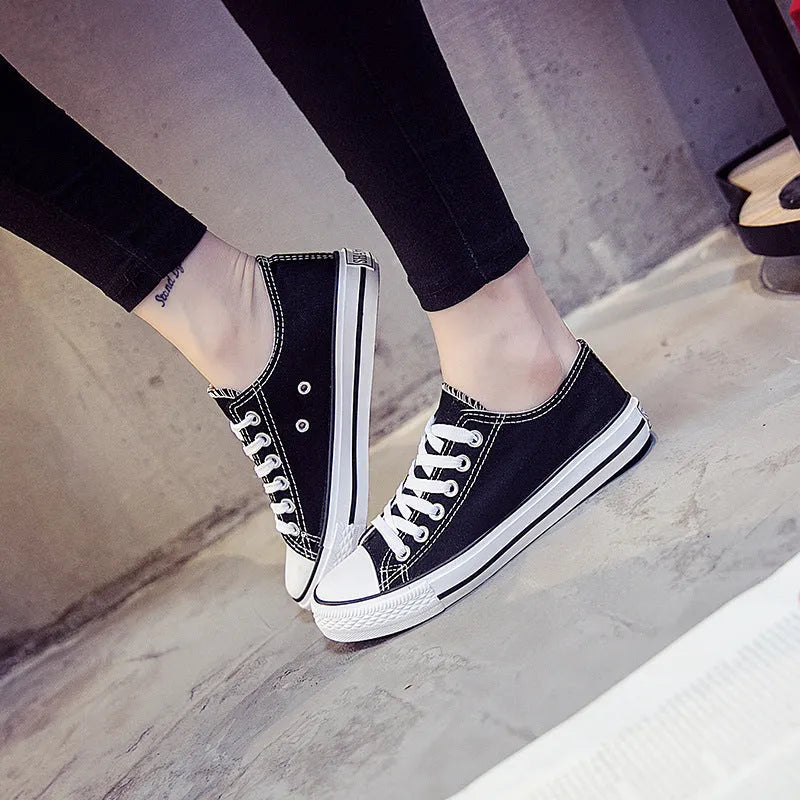 Women's solid-colour casual canvas shoes in black, white and black, white and red, or all black colourways.