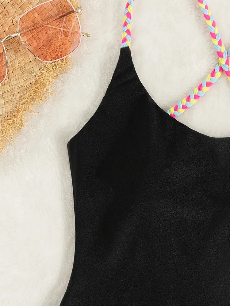 Black backless one-piece swimsuit for women made from nylon fabric.