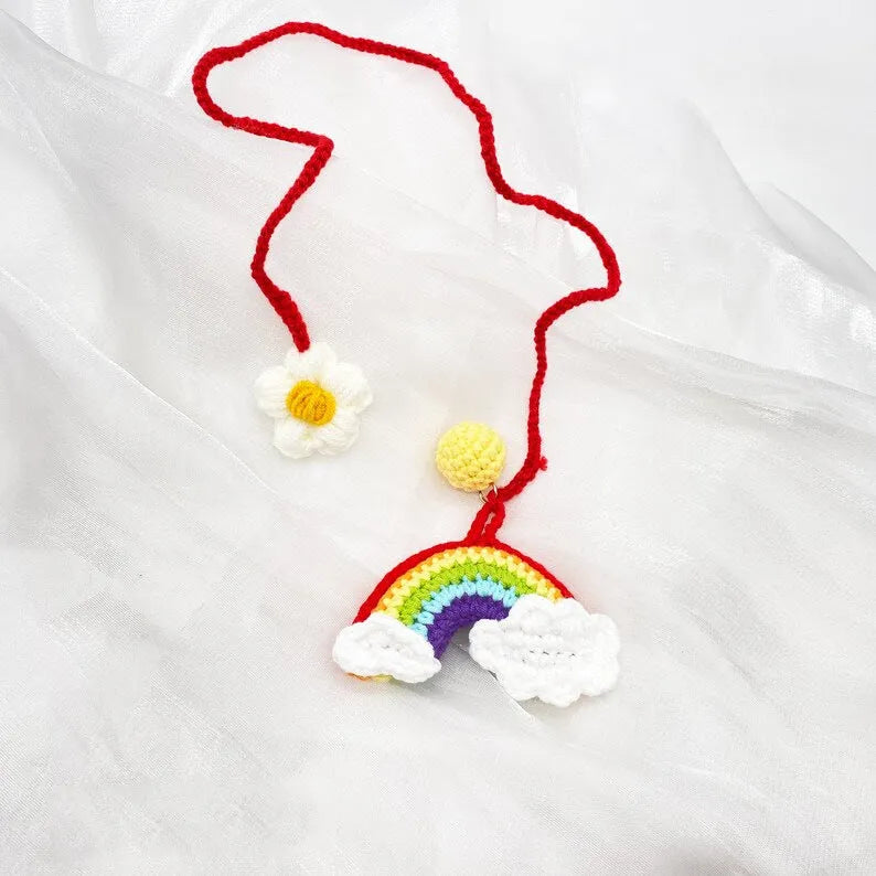 Handmade crocheted wool car pendant with rainbow colours hanging from car mirror