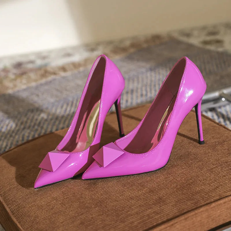 Women's pink patent leather pointed toe stiletto high heels with buckle and rivet decoration