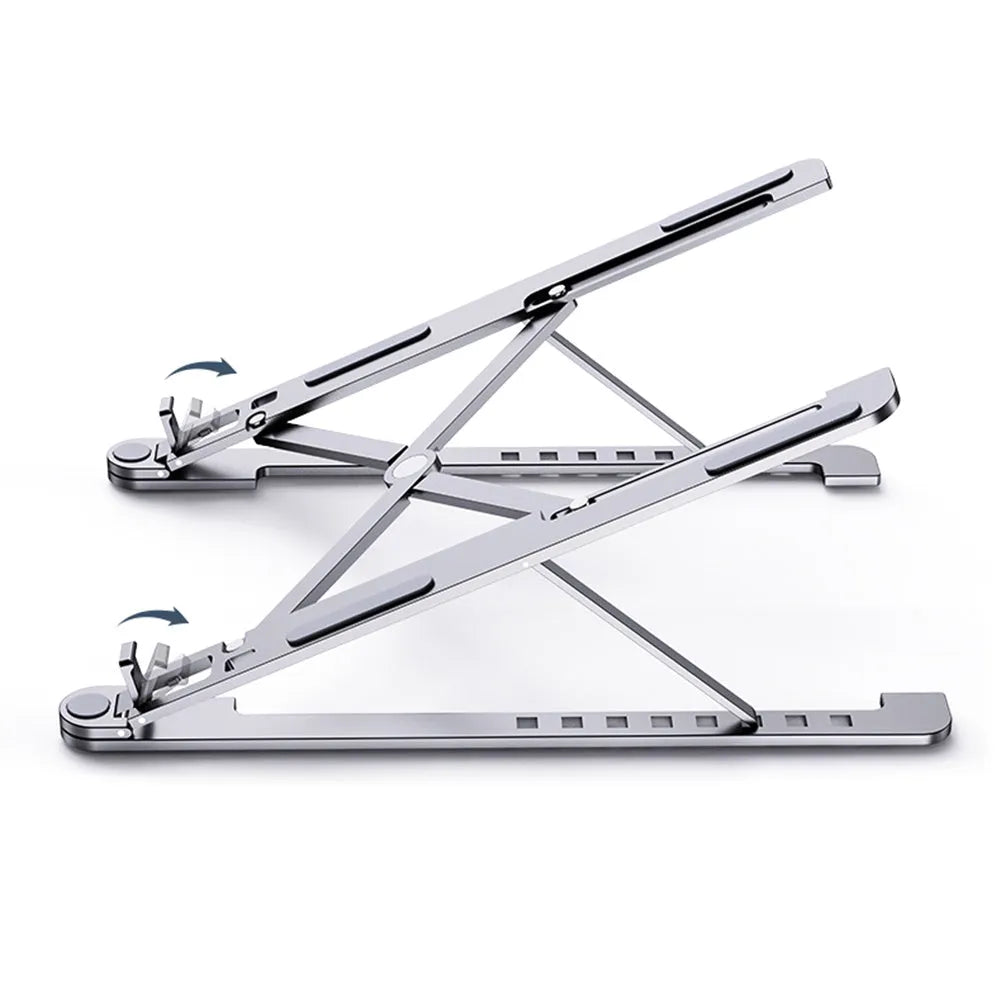 A folded aluminium laptop stand in silver next to an open laptop, demonstrating its compact size.