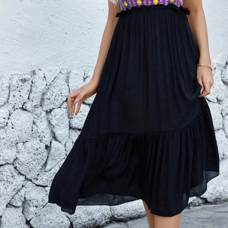Purple sleeveless dress with hand-hooked floral embroidery pattern, modelled on an adult woman.