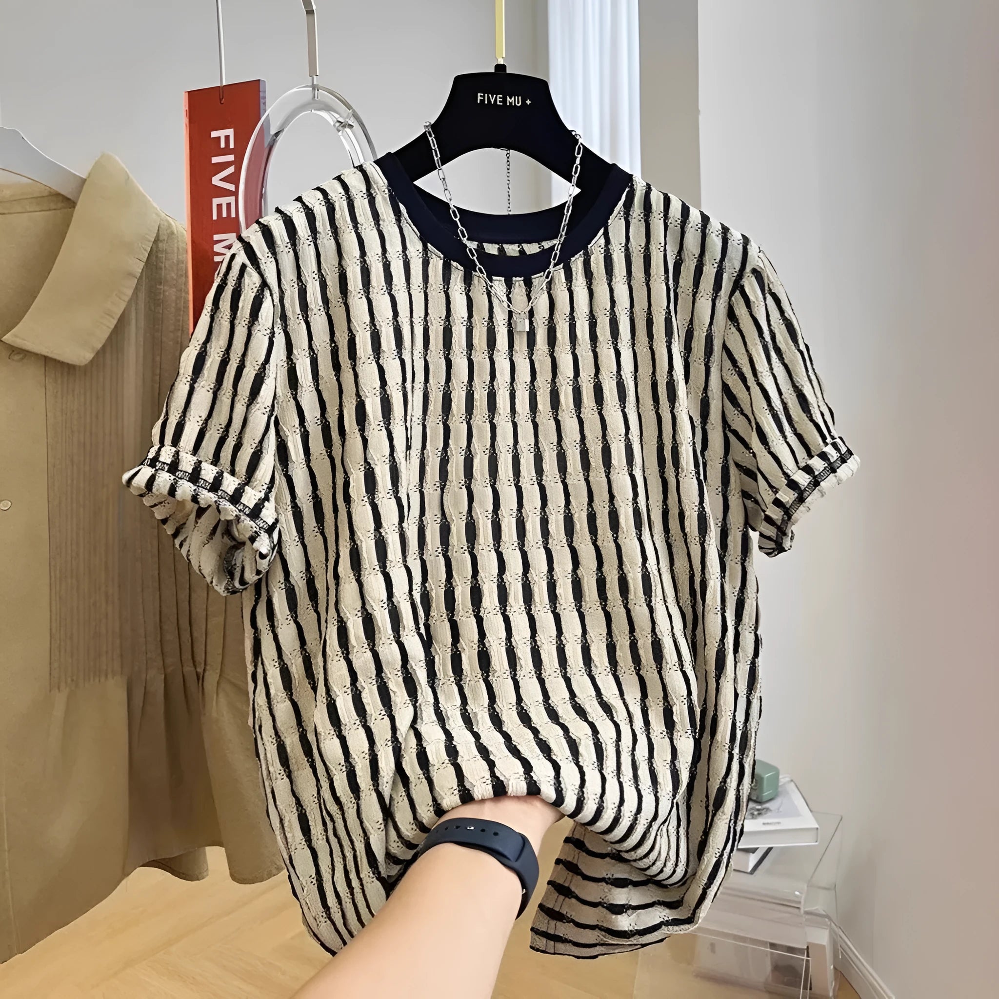 Men's black striped short sleeve shirt in loose silk-linen blend on hanger