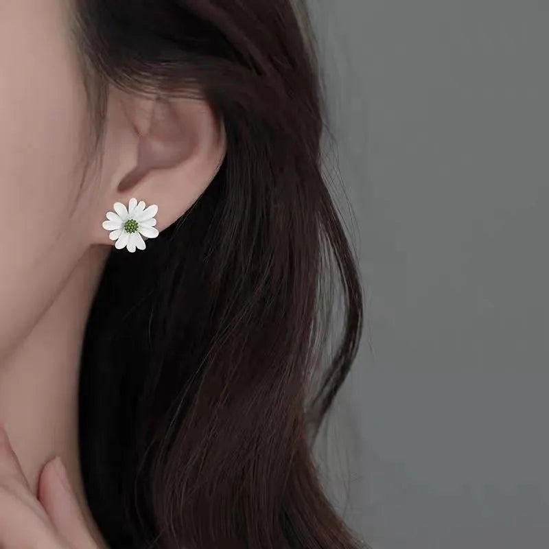 A pair of cartoon-style flower stud earrings in alloy, shown in a two-tone colour option.