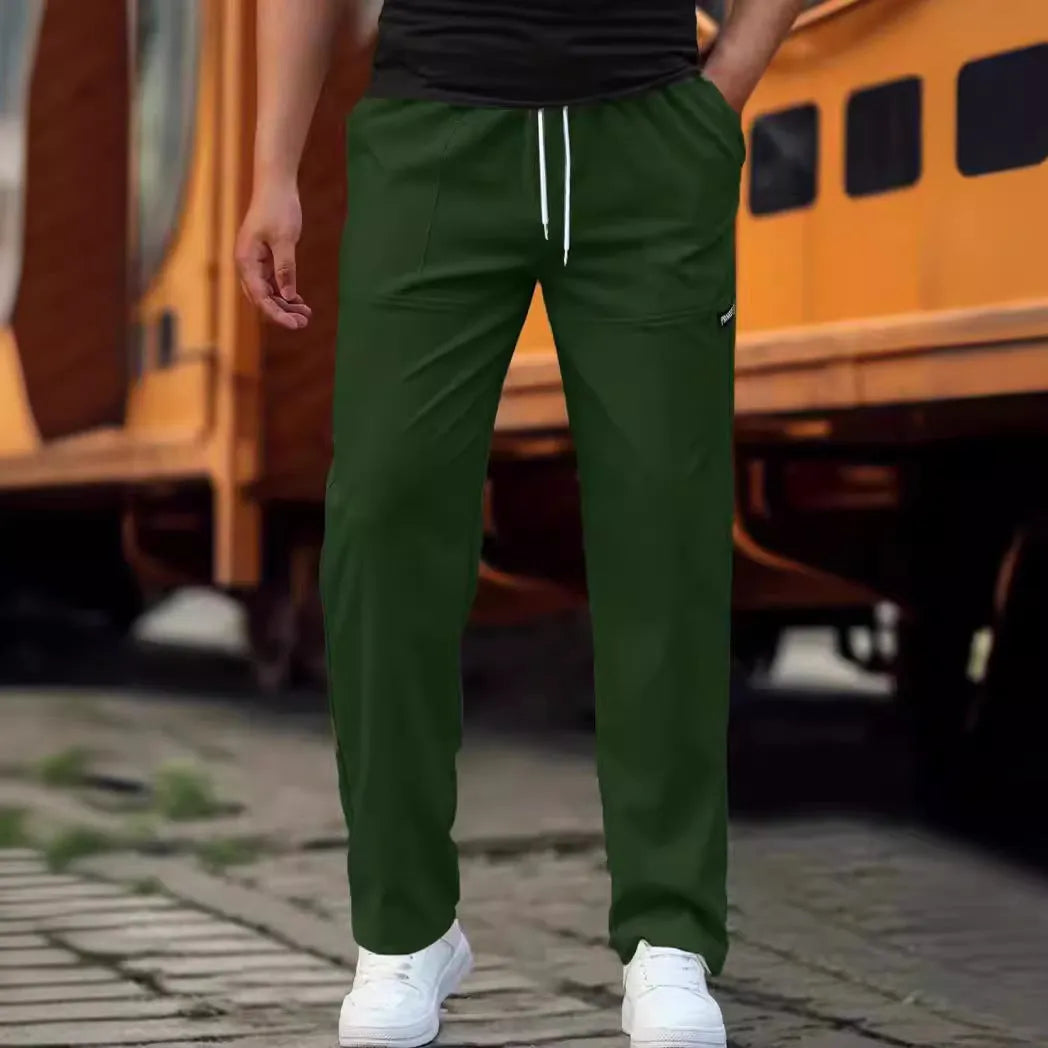 Men's polyester trousers in light grey, shown laid flat, suitable for spring and autumn wear.