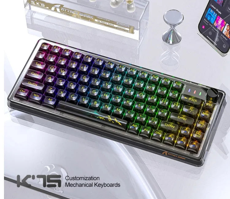 Attack Shark K75 RGB wireless mechanical keyboard with transparent black case, illuminated keys, and included accessories.