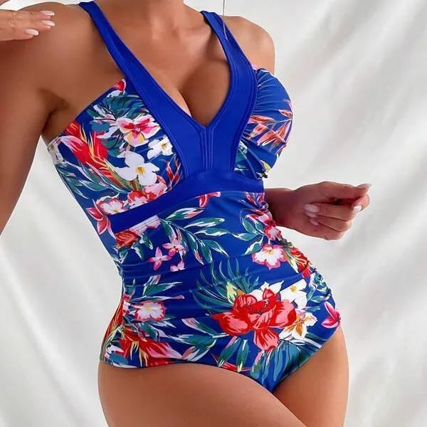 Women's floral patterned, backless one-piece swimsuit on a hanger