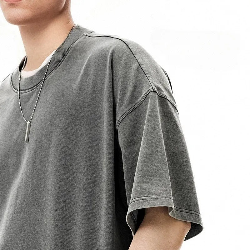 Men's loose vintage washed-out cotton t-shirt in khaki light colour, showing drop-shoulder sleeves and casual fit