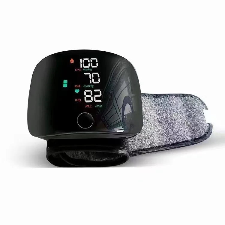 Black wrist blood pressure monitor with digital display and USB charging port