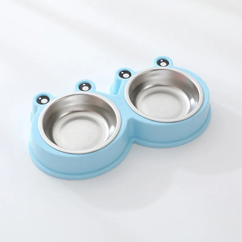 Stainless steel frog-shaped double bowl for pet food and water in blue, green, or pink.