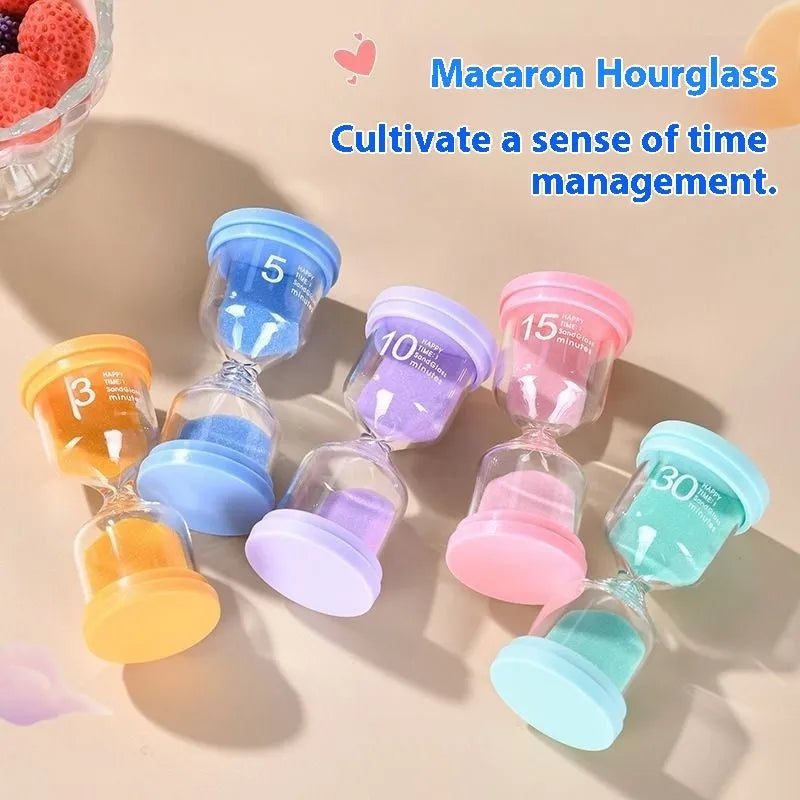 Handmade glass sand timer in blue, showing sand flowing, on a wooden table.