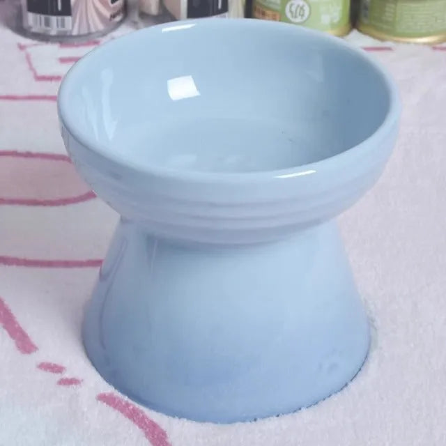 Black ceramic pet bowl with a raised foot and high neck guard for dogs and cats.